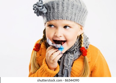 Lovely Little Girl Eating Chocolate Candy