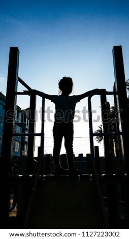 lovely little girl on a children’s slide