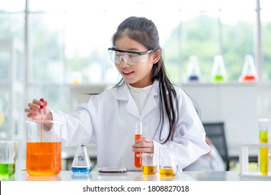 Lovely little girl scientist enjoy and excite to examine the color chemical in laboratory by using dropper with day light. Concept of good practice and education of science for children support. - Powered by Shutterstock