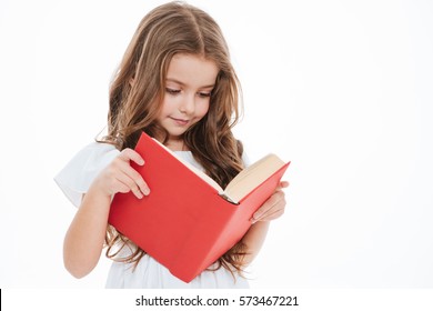 Lovely little girl standing and reading book over white background