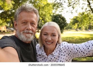 Lovely Mature Couple Taking Selfie In Park