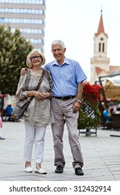 Lovely Mature Couple Walking Through The City