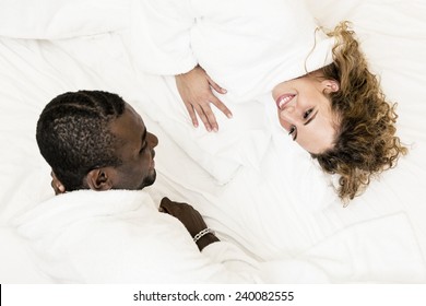 Lovely Mixed Race Couple Lying On Bed.