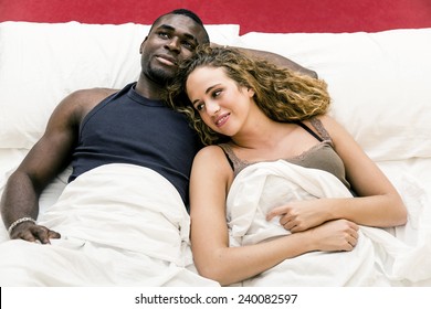 Lovely Mixed Race Couple Lying On Bed.