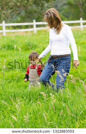 Similar – Image, Stock Photo Little girl and woman carrying basket with apples