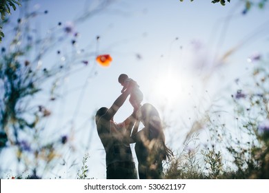 The Lovely  Mother And Father  With Baby On Walk