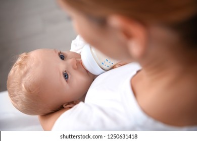 Lovely Mother Feeding Her Baby From Bottle, Closeup