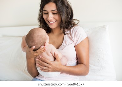 Lovely Mother Holding Newborn Baby In Arms