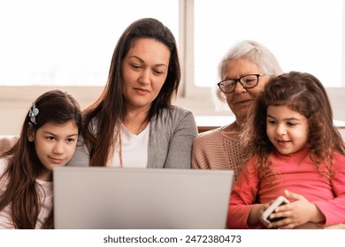 Lovely multigenerational family with laptop spending time together Indoors at home living room. Unity, happiness, affection, love, care concept. - Powered by Shutterstock