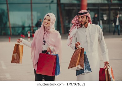 Lovely muslim couple taking a walk after shopping. concept