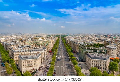 Lovely Panoramic Aerial View Of The Famous Avenue Des Champs-Élysées In Paris On A Nice Sunny Day With A Blue Sky At The Horizon. It Is One Of The Most Recognisable Avenues In The World.