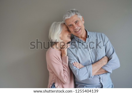  Lovely portrait of attractive senior couple on grey background                              