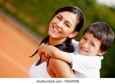 Lovely portrait of a mother and son at the tennis court - Powered by Shutterstock