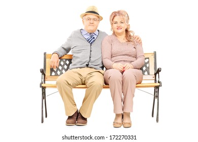 Lovely Senior Couple Sitting On Bench, Isolated On White Background