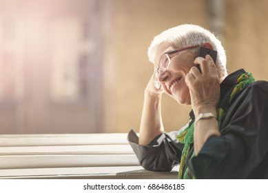 Lovely senior lady having a fun conversation with her friend or a relative