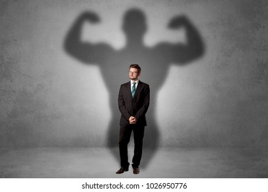 Lovely serious businessman standing with a muscular powerful shadow behind his back