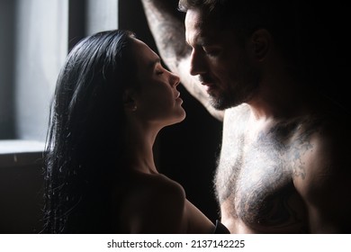 Lovely sexy couple. Shirtless muscular man embracing kissing girlfriend. Young couple in love. Sexy passionate couple hugging. Sensual couple posing together in studio. Handsome young lovers.