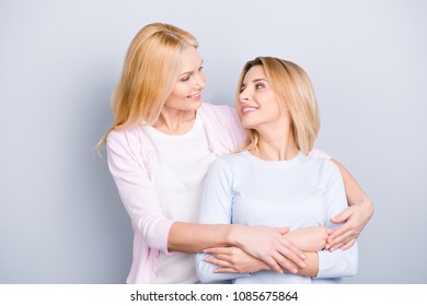 Lovely single grandma embracing adult charming attractive pretty child, family with one parent looking at each other isolated on grey background - Shutterstock ID 1085675864