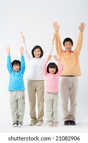 Lovely Smiling Family - raising hands for cheers - Shutterstock ID 21082906