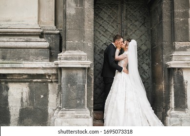 Lovely wedding couple kissing in the old city