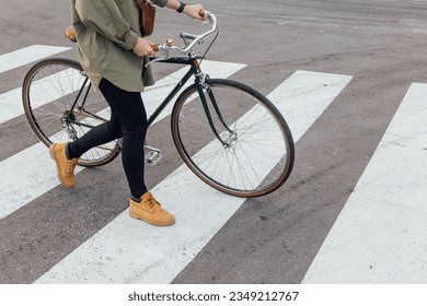 Lovely woman goes the road with bicycle on crosswalk - Powered by Shutterstock