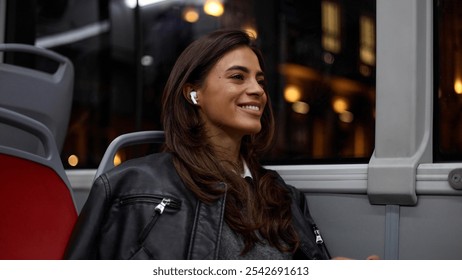 Lovely woman relaxing while riding on a city bus in the evening - Powered by Shutterstock