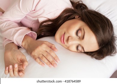 Lovely woman is sleeping on soft pillow
