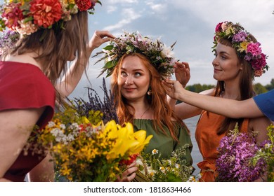 Lovely women's in flower wreaths in nature. Ancient pagan origin celebration concept. Summer solstice day. Mid summer. - Shutterstock ID 1818634466