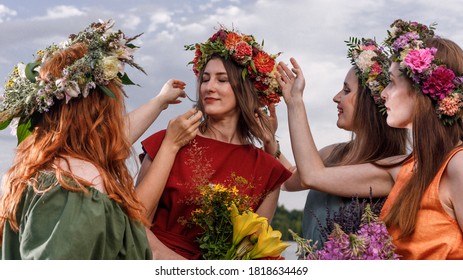 Lovely womens in flower wreaths in nature. Ancient pagan origin celebration concept. Summer solstice day. Mid summer. - Shutterstock ID 1818634469
