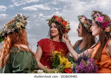 Lovely women's in flower wreaths in nature. Ancient pagan origin celebration concept. Summer solstice day. Mid summer. - Shutterstock ID 1818634481