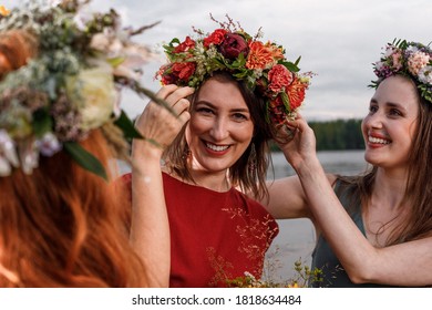 Lovely women's in flower wreaths in nature. Ancient pagan origin celebration concept. Summer solstice day. Mid summer.