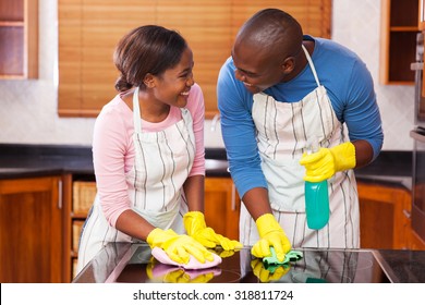 Lovely Young Black Couple Cleaning Together In Their Kitchen