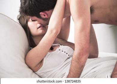 Lovely young couple in bed. Amorous young couple