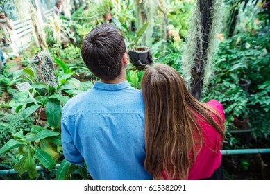 Lovely Young Couple In Colorful Botanical Garden