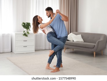 Lovely Young Couple Dancing Together At Home