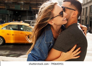 Lovely young couple dressed in casual style walks around Soho and New York city in morning lights