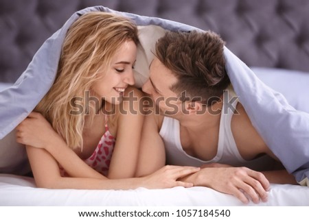 Similar – Happy young couple in love smiling under duvet cover