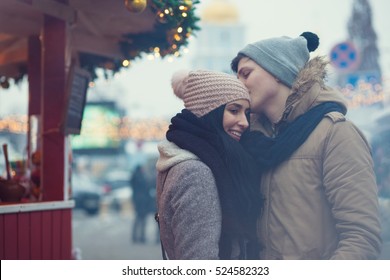 Lovely young couple on Christmas market - Shutterstock ID 524582323