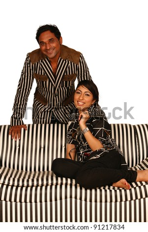 Lovely young couple relaxing watching tv and smiling