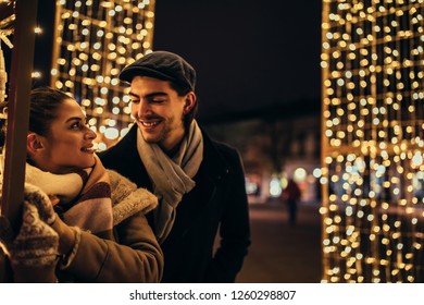 Lovely young couple spending Christmas time together outdoors - Shutterstock ID 1260298807