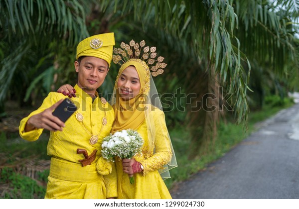 Young Malay Woman Using Mobile Phone Taking Selfie Stock Photo Download Image Now Istock