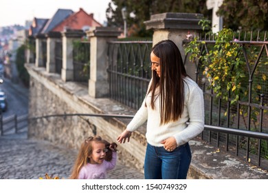 Lovely young mom and daughter wallk
