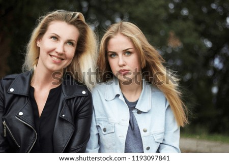 A lovely young mother and her adorable teenage daughter