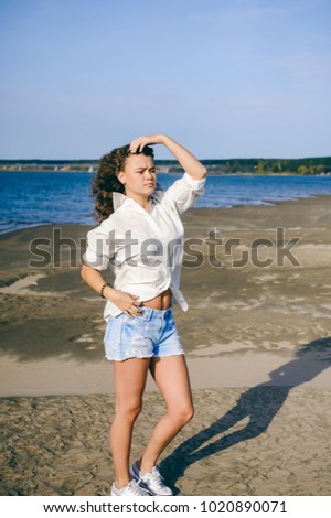 Similar – Young woman standing with closed eyes at the Baltic Sea beach