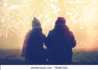 Lover women and men asians.sit hug hands watch the fireworks. In New Year's Mountain. Thailand