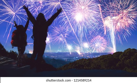 Lover women and men asians. Stand and raise hands watch the fireworks. Happy on the day of the celebration New year day on Mountain in Thailand.