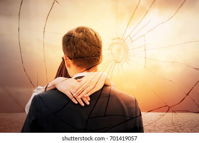 Lovers back hugging over dramatic sunset sky background.Sad young couple in relationship difficulties. Broken heart or divorce concept, double exposure. Break off, withdraw, disengage one's engagement