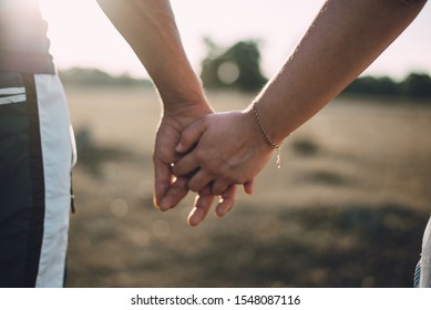 Lovers Couple Holding Hands In A Forest. Summer,spring