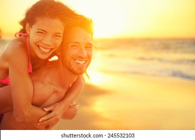 Lovers couple in love having fun dating on beach portrait. Beautiful healthy young adults girlfriend piggybacking on boyfriend hugging happy. Multiracial dating or healthy relationship concept. - Powered by Shutterstock