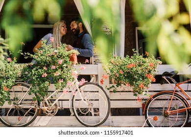 Lovers Find Place For Secret Dates. Blonde Woman And Bearded Man Happy To See Each Other. Man And Woman Or Lovers At Balcony On Sunny Day Spend Time Together. Secret Date Concept.